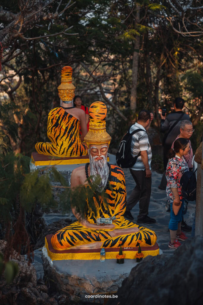 Statues of men dressed in tiger pattern clothes on Mount Phousi in Luang Prabang