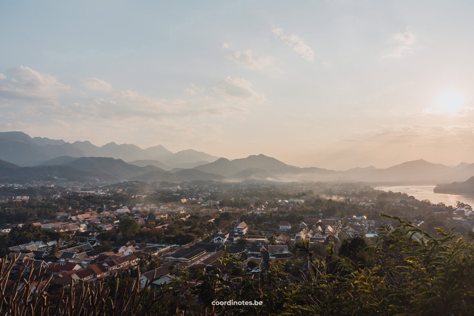 The 360 view of the city of Luang Prabang from Mount Phousi with towering mountains in the background.