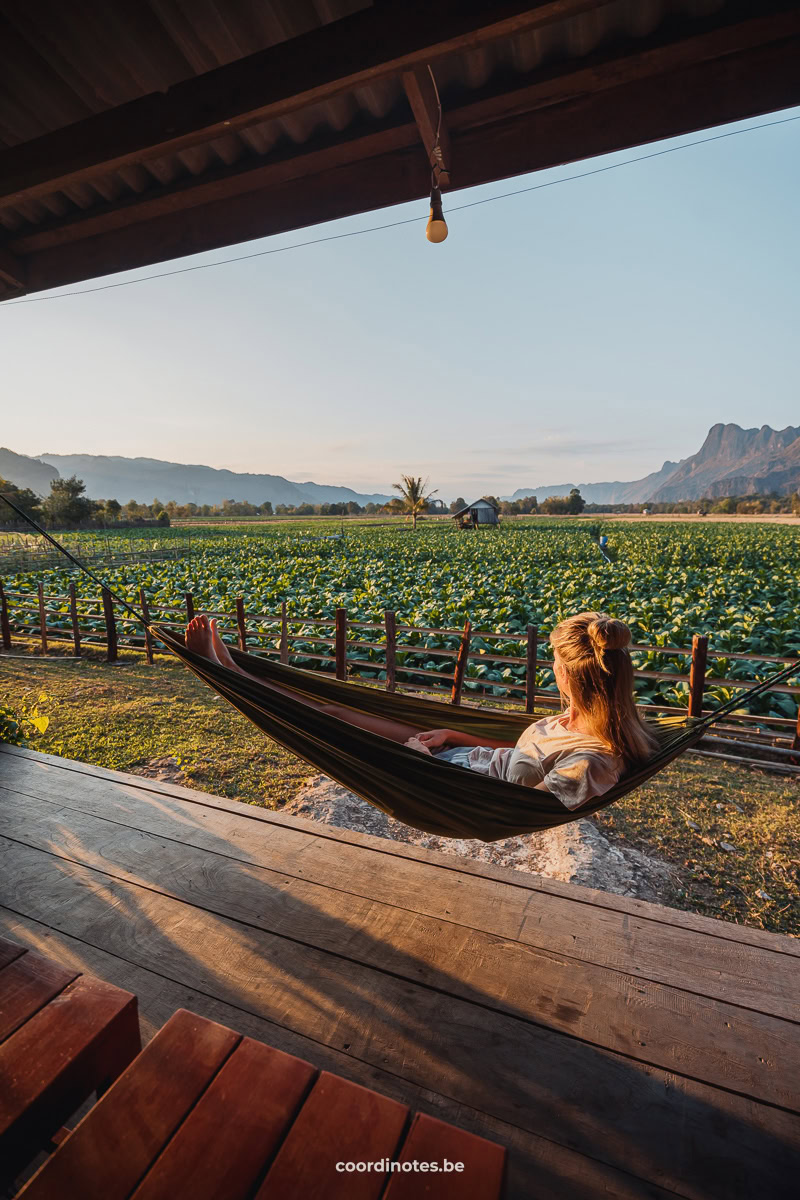 View from the balcony of the fields from Khamchalern Guesthouse at Kong Lor Cave with towering mountains in the background.