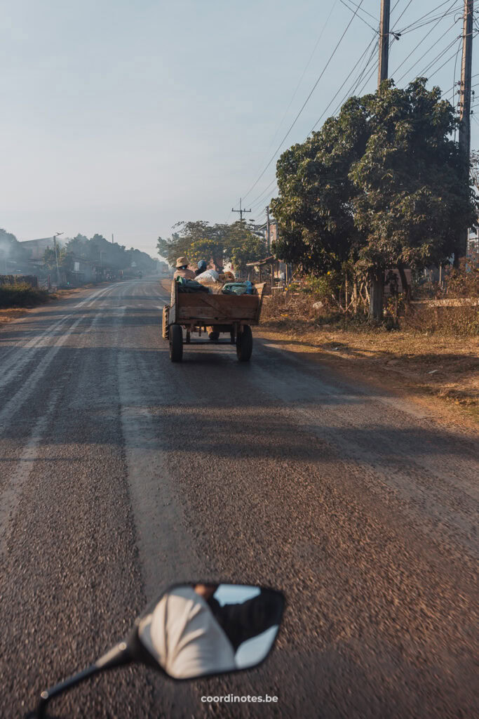 Driving with a scooter behind a tractor during the Bolaven Plateau Loop