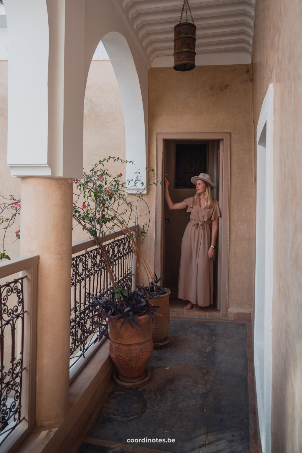 Sarah standing in the doorway at the end of a corridor in Riad Dar Ten