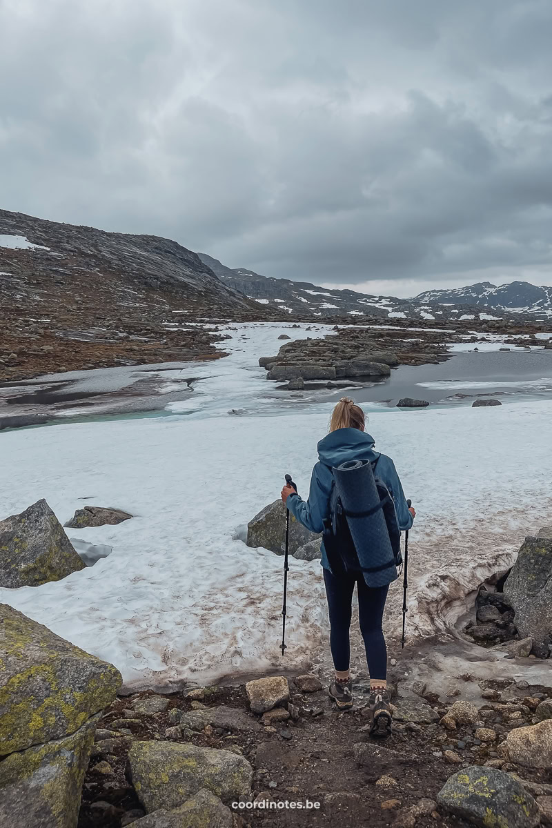 Sarah hiking to Trolltunga over a trail that is still covered in snow