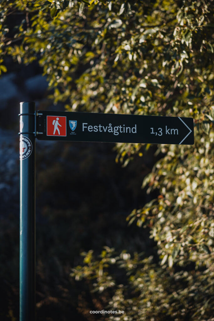 The image shows a sign pointing to "Festvågtind," a hiking destination that is 1.3 kilometers away.