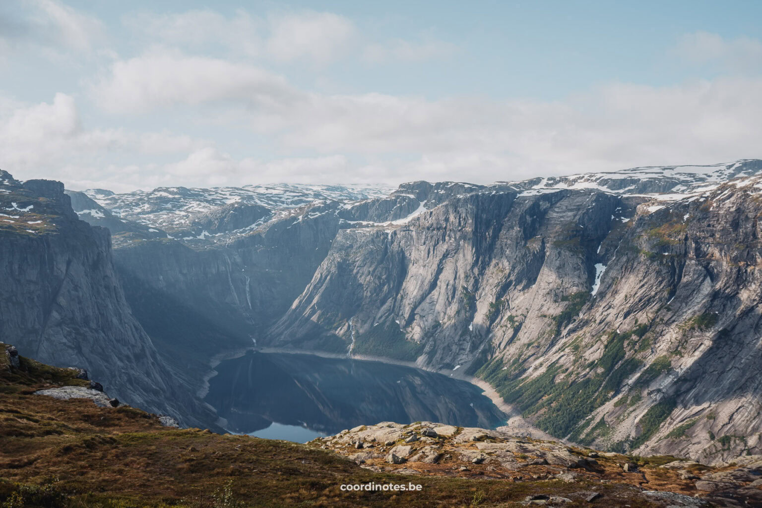 View over a lake surrounded by mountains during the hike to Trolltunga