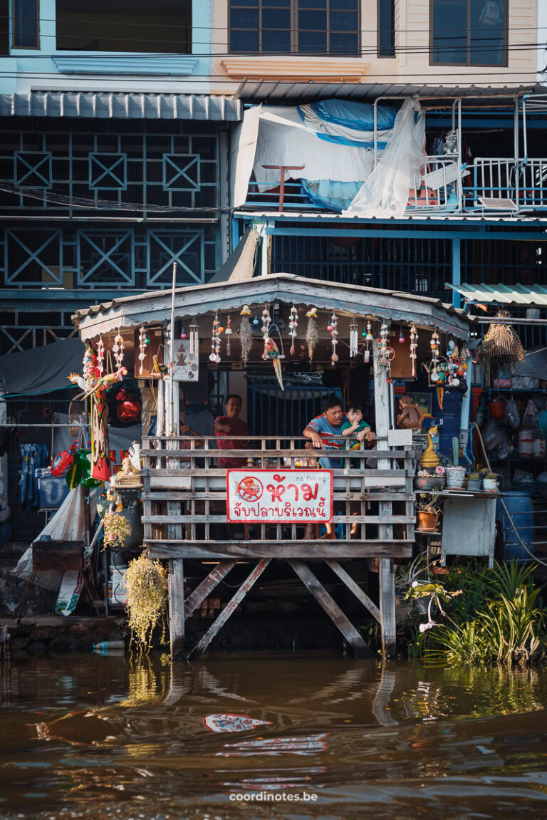 Father with his child on the shore during a boat trip in Bangkok