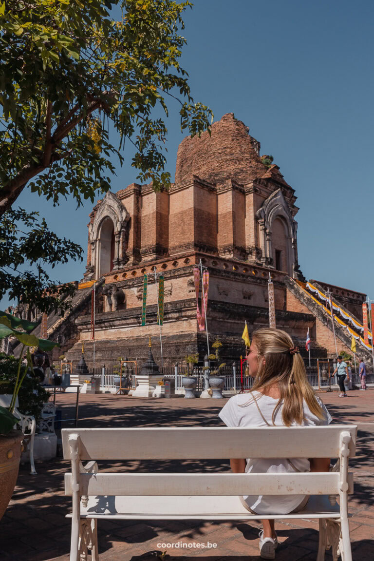 Sarah sitting on a bench in front of the huge ruin of the Thai Wat Chedi Luang Temple in Chiang Mai